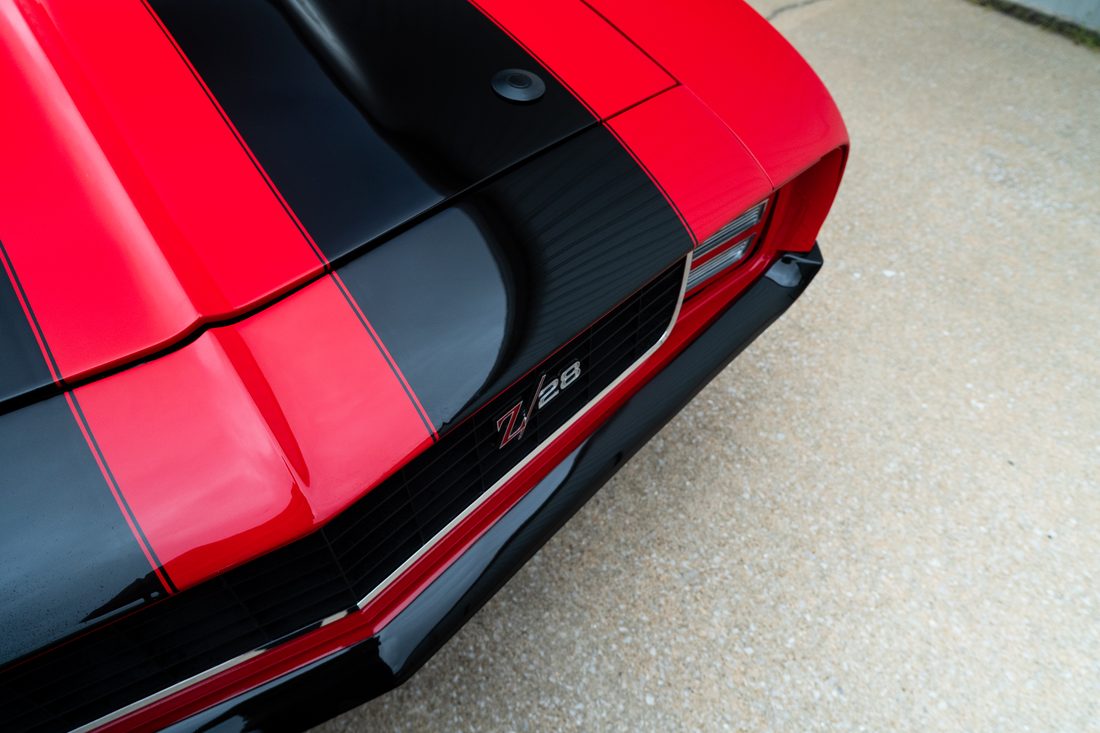 Red and black hood stripes and Z/28 badge on a classic Camaro